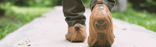 A hiker wearing anti-blister socks while walking on a rugged trail to prevent blisters on long-distance walks